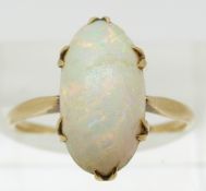 A 9ct gold ring set with an opal cabochon (size M)