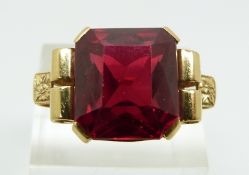 An 18ct gold ring set with a large synthetic ruby (size S/T)