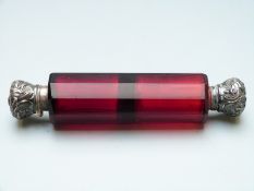 Red glass double ended scent bottle with white metal lids, one hinged, one having screw fitting,