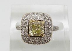 An 18ct white gold ring set with a cushion cut fancy yellow diamond of approximately 1.51ct