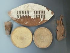 Two North African leather shields, Zulu style shield and a small drum, largest item 80cm