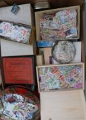 A tray containing a substantial quantity of loose all world stamps in tins, packets etc