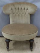 Circular 19thC nursing chair with button back, raised on turned front legs