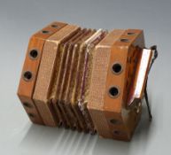 Anglo/German concertina with twenty one buttons, wooden fretworked ends and five-fold bellows