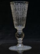 A large 19thC cut glass goblet with faceted and engraved bowl raised on multi-faceted and knopped