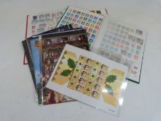 A box containing two stockbooks of modern GB postage stamps and smiler sheets