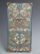 A 19thC Chinese embroidered cuff mounted in a glazed frame, 40 x 20cm