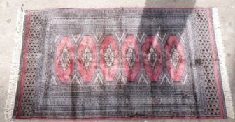 Pink and grey ground handmade rug with six central guls, 165x92cm