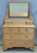Pine dressing chest with bevelled edge mirror flanked by two drawers, the base fitted two over two