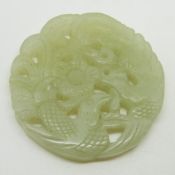 Chinese carved and pierced jade plaque with bird and foliage decoration, diameter 5cm
