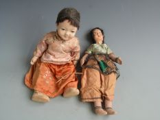 Two lacquer dolls, one Japanese with painted features and silk outfit (40cm tall) the other Indian