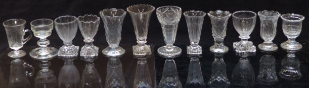 Twelve 19thC and later cut glass vases, some with knopped stems and some raised on square cut bases,