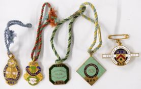 Five c1920s Cheltenham Steeplechase Club enamel badges, each with member's number, comprising