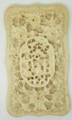 A 19thC carved ivory card case with relief decoration of village scenes, 9.2 x 5.2cm