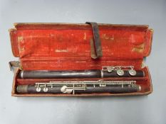 A 19thC rosewood flute with nickel keys stamped A.H.Langlois, London, in original leather case