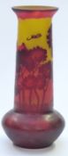 Galle style carved cameo glass vase decorated with trees and mountains in red over yellow ground,