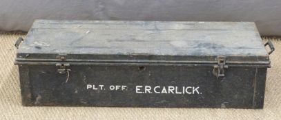 Black painted metal travelling trunk, painted to front with name Plt Off E.R.Carlick, L107 x D43 x