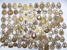 A large collection of Victorian and later horse brasses to include barrel, star, crescent and