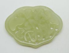 A 19thC Chinese carved and pierced jade plaque with archaic decoration, length 5.8cm