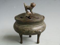 A bronze tripod censer / koro decorated with birds among bamboo friezes and with Dog of Fo finial,
