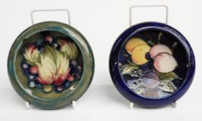 Two Moorcroft pin dishes decorated in 'Wisteria' and 'Leaf and Berry' patterns, D12cm