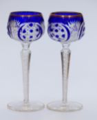 A pair of flash overlaid cut glass hock glasses with blue overlay over clear ground, gilt rims,
