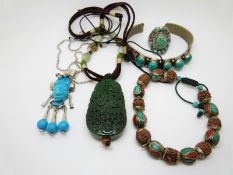 A silver pendant set with a carved African head, silver chain, carved hardstone pendant, etc