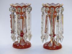 A pair of Victorian double overlaid cut glass lustres with gilt, pink and white decoration over a
