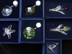 Seven Swarovski cut glass ornaments comprising two flowers, sailing ship, starfish and three