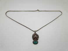 Chinese pendant in the form of a dragon set with turquoise, on silver chain