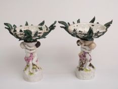 Pair of continental figural comports, one with blue crossed swords marks to base, H27cm