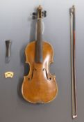 Late 19th/early 20thC unlabelled half size violin, with 32cm two piece back, complete with bow, in