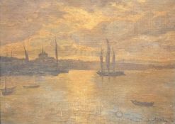 Continental harbour scene boats with town beyond and low sun reflected in the sea, indistinctly