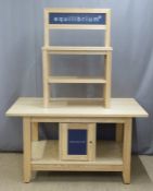 A pine or similar shop display stand with two shelves above the top, the base fitted cupboards and