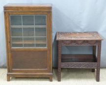 Carved occasional table and an oak glazed bookcase