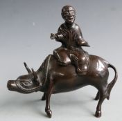 A 19thC Chinese bronze model of an ox and man, H16cm