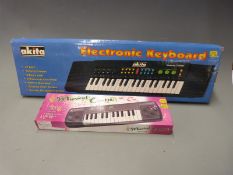 Two small electronic keyboards in original boxes