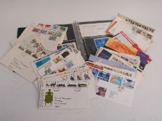 A first day cover album and a quantity of loose covers