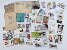 A collection of cigarette cards including Churchman's footballers, Typhoo black and white photograph