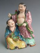 A Japanese figural group with impressed mark to base, H 21cm