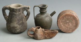 Islamic vessels including oil lamp, carved stone twin-handled pot and a circular stove