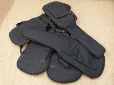 Five padded soft guitar carry cases.