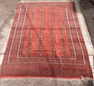 Orange ground handmade rug with repeating design and multiple borders, 290x219cm