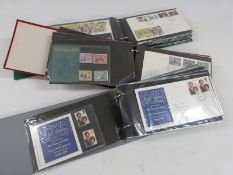 Three albums of first day covers and presentation packs