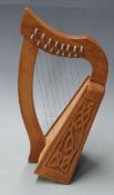 Miniature lap harp with carved Celtic design and eight steel strings, 37cm tall