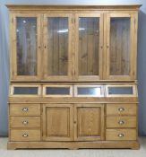 Pine dresser or shop fitting haberdashery counter, the top having four glazed doors, the base fitted