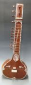 Small or child's size Indian sitar the gourd back with carved and inlaid decoration, in original