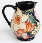 Moorcroft jug decorated with flowers on a blue ground, E.R Golden Jubilee and 2001 backstamp to