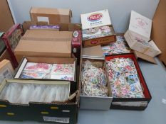 A tray containing a substantial quantity of loose all world stamps in tins, packets etc