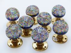 A set of eight Perthshire millefiori glass paperweight door knobs, each with a central cane signed P